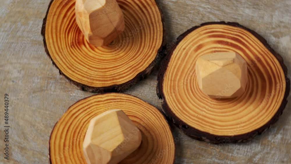Three wooden irregular blocks placed on wood slices. Table spin. 