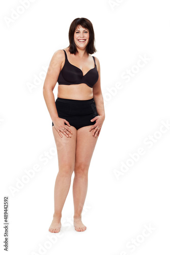 Confident in who she is. Full length studio portrait of a young woman modeling underwear isolated on white.