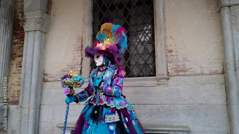 Venice, Italy - February 2022 - carnival masks are photographed with tourists in San Marco square Venice, Italy - February 2022 - carnival masks are photographed with tourists in San Marco square