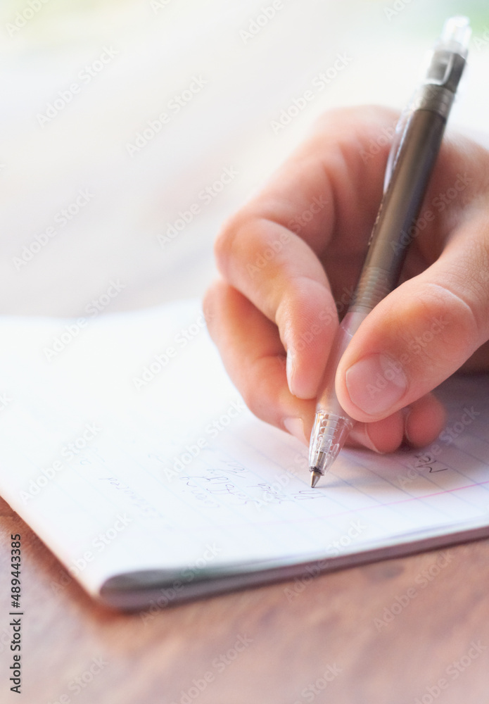 Getting his thoughts down on paper. Cropped shot of a businessman writing on a notepad. Getting his thoughts down on paper. Cropped shot of a businessman writing on a notepad.