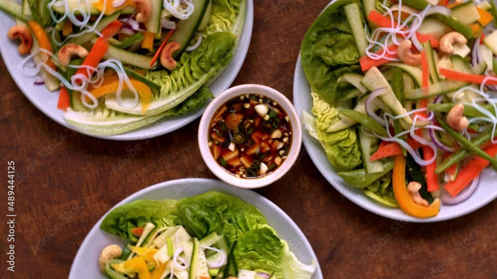 Rice noodle salad with fresh vegetables and cashew nuts with spicy sauce. Vietnamese cuisine, top view, table spin. Rice noodle salad with fresh vegetables and cashew nuts with spicy sauce. Vietnamese cuisine, top view, table spin.
