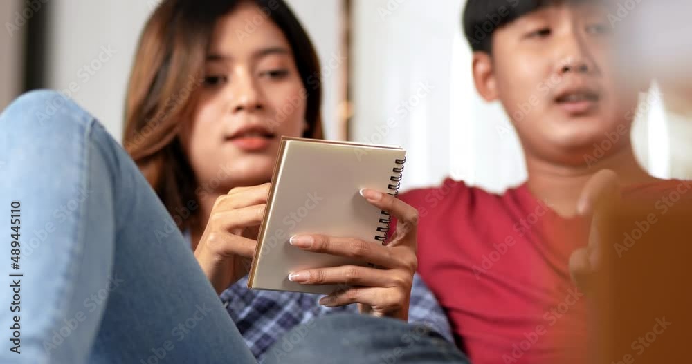 Selective focus, Close up, Young couple sitting on floor and use tablet while counting boxs after relocation in their new home, pretty woman checking on notebook, new house concept Selective focus, Close up, Young couple sitting on floor and use tablet while counting boxs after relocation in their new home, pretty woman checking on notebook, new house concept