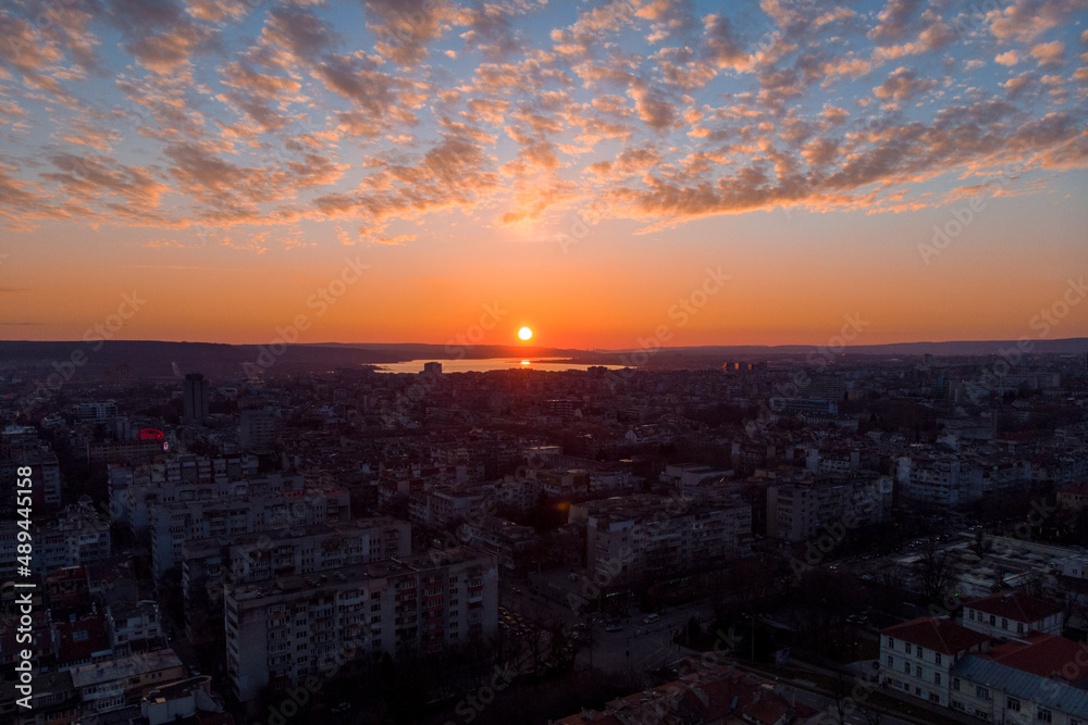 Cityscape from above. Sunset with dramatic clouds with drone