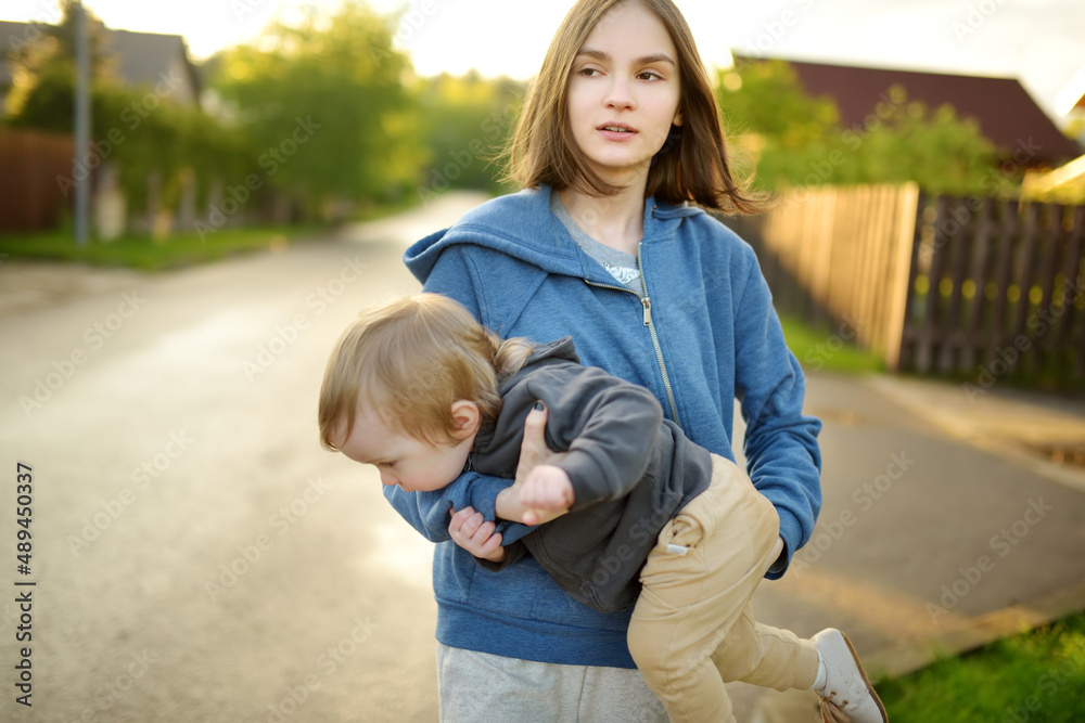 cute-big-sister-cuddling-with-her-toddler-brother-adorable-teenage