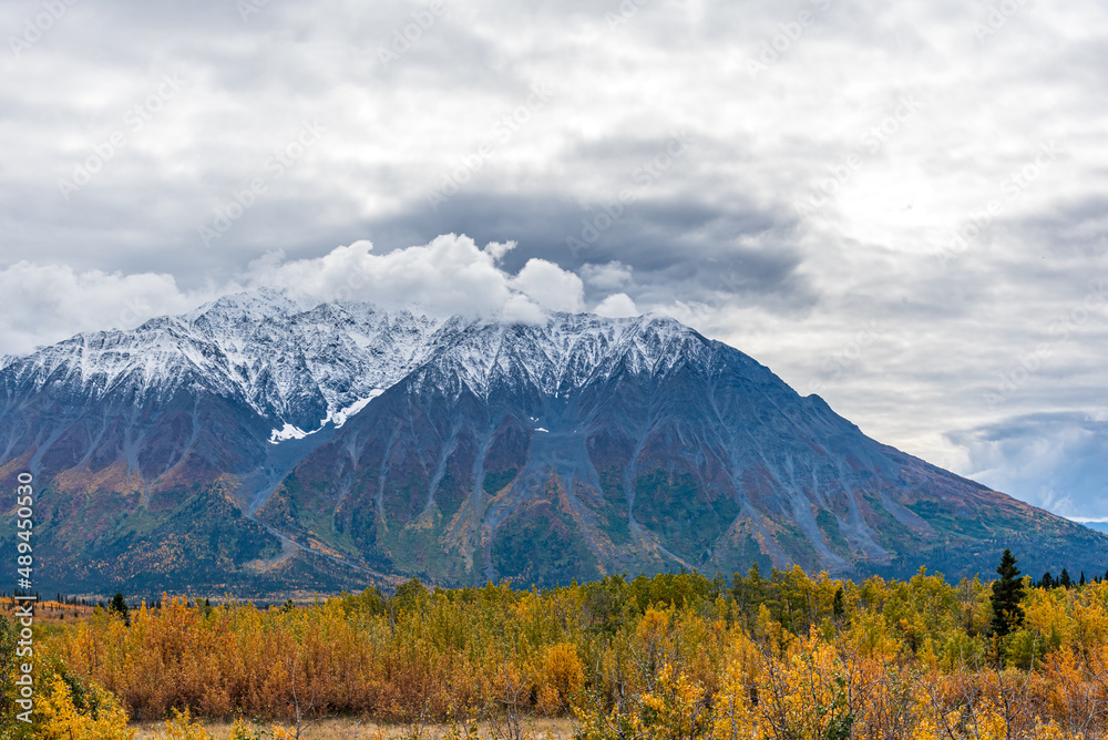 Incredible mountain landscape in northern Canada with snow capped mountains in the fall, autumn season with spectacular scenic views. 