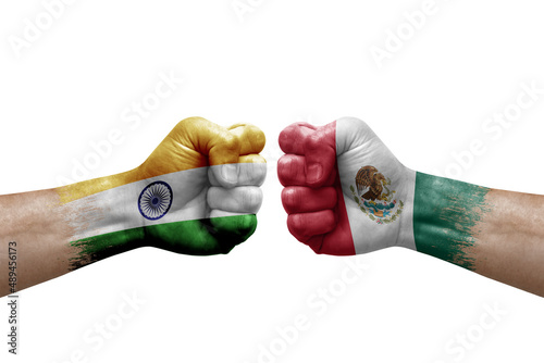 Two hands punch to each others on white background. Country flags painted fists, conflict crisis concept between india and mexico