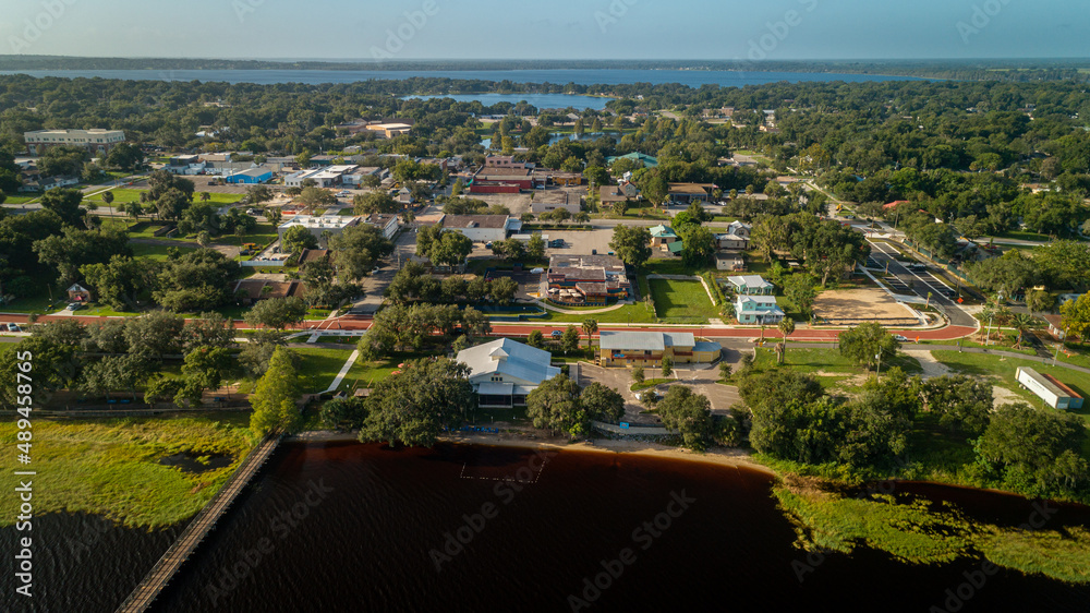 Drone shot over the bustling historic downtown Clermont on the waterfront edge of Lake Minneola.