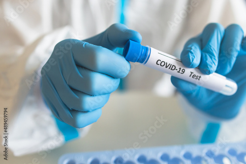 Process of coronavirus PCR antigen testing examination by nurse medic in laboratory lab, COVID-19 swab collection kit, test tube for taking OP NP patient specimen sample, patient receiving test