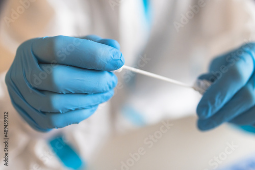 Process of coronavirus PCR antigen testing examination by nurse medic in laboratory lab, COVID-19 swab collection kit, test tube for taking OP NP patient specimen sample, patient receiving test