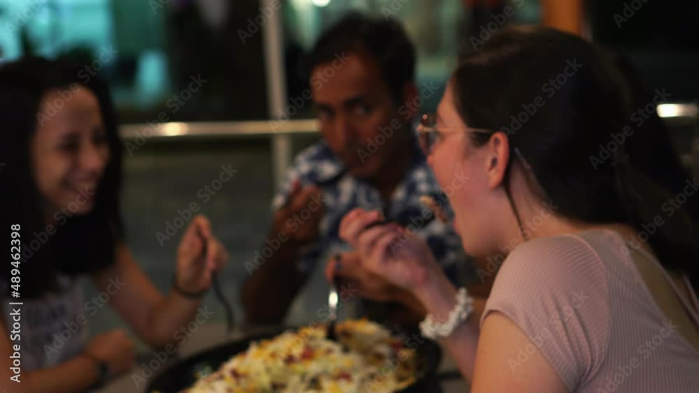 Friends sitting at the table in outdoor restaurant