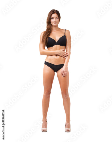 Her confidence is sexy. Full length shot of an attractive young woman posing in lingerie against white background.