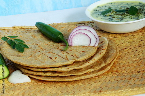 indian gujarati traditional food roti,rotla or indian flat bread with spinach and beans kadhi photo