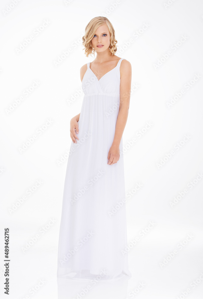 Pure elegance. Studio shot an attractive young woman in white dress. Pure elegance. Studio shot an attractive young woman in white dress.