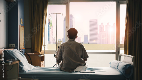 patient sat on the bed and looked out the window in the hospital alone and had stress, boredom, loneliness, anxiety. / Health care and medical