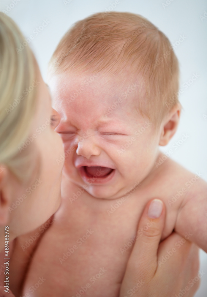 Soothing her baby. Closeup cropped shot of a mother cradling her crying infant. Soothing her baby. Closeup cropped shot of a mother cradling her crying infant.