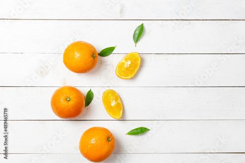 Fresh oranges on a white wooden background