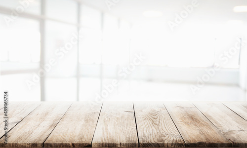 Empty Wood table on blur kitchen window background for panoramic banner © kanachaifoto