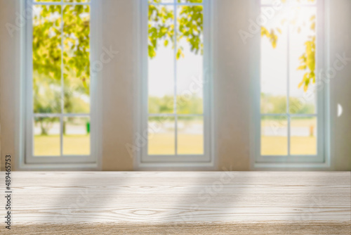 Blurred wood tables in the kitchen on the window background in the morning autumn foliage  for editing in your product