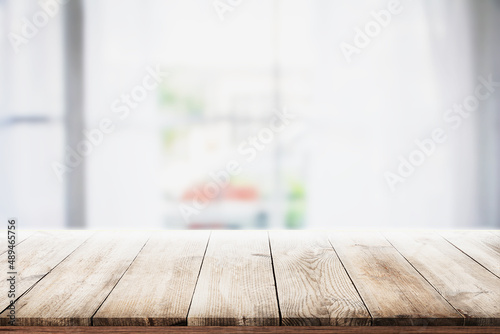 Fotografie blur wooden table in the kitchen on the window background in the morning