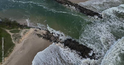 Mooball Creek mouth Pottsville rock walls broken by waves in king tides