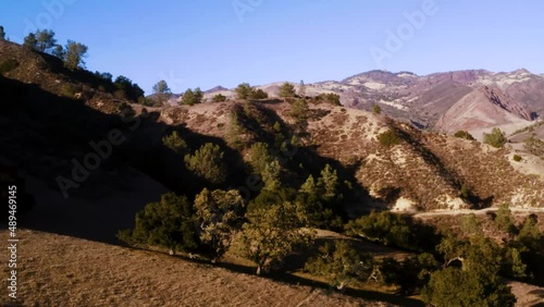 Beautiful outdoor ranch landscapes, shots of a overlanding Toyota 4Runner with a rooftop tent on an off road adventure, vast golden mountain tops with long views of valleys and oak trees and incredibl