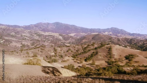 Beautiful outdoor ranch landscapes, shots of a overlanding Toyota 4Runner with a rooftop tent on an off road adventure, vast golden mountain tops with long views of valleys and oak trees and incredibl