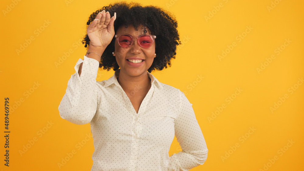 Happy smiling African American woman with afro hairstyle happy positive smile chat email laptop isolated over  color background.