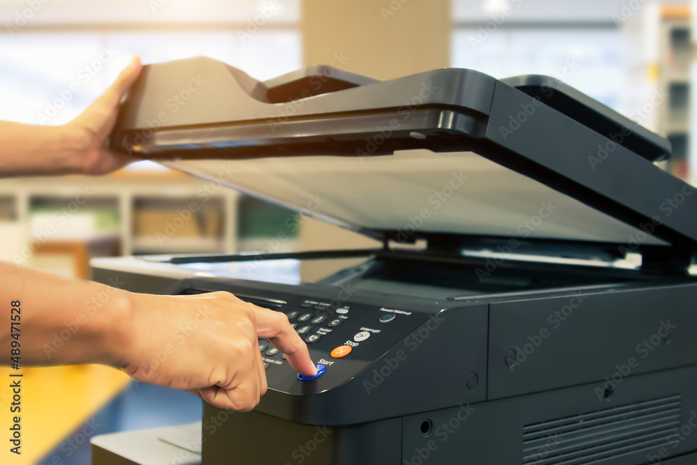Copier printer, Close up hand office man press copy button on panel to using the copier or photocopier machine for scanning document printing a sheet paper and xerox photocopy. Copier printer, Close up hand office man press copy button on panel to using the copier or photocopier machine for scanning document printing a sheet paper and xerox photocopy.