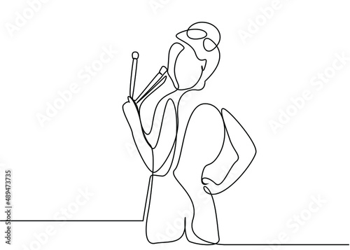 beautiful woman holding makeup brushes turns around and poses