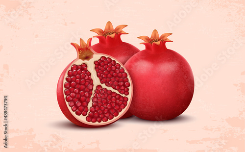 Set of two fresh pomegranates with half pieces of pomegranate isolated on a light red background