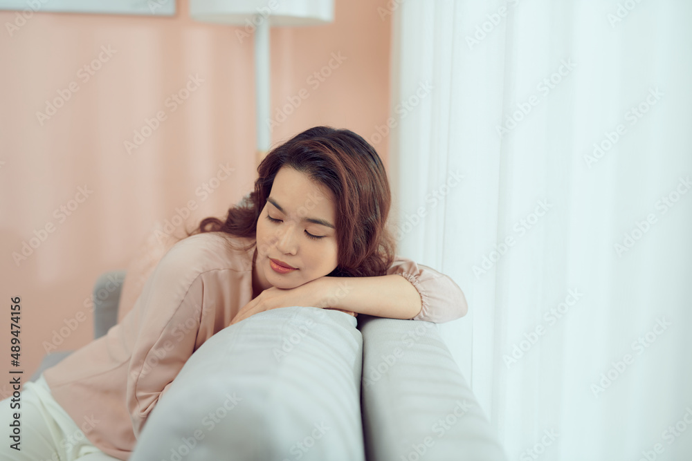 Tired attractive woman taking a nap on a sofa, close up of her face Tired attractive woman taking a nap on a sofa, close up of her face