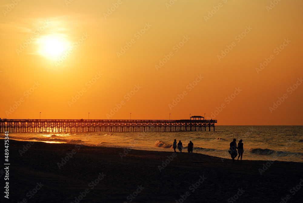 People stroll Myrtle Beach's Grand Strand and greet the sunrise