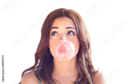 Blowing bubbles. An attractive young woman blow bubbles with gum.