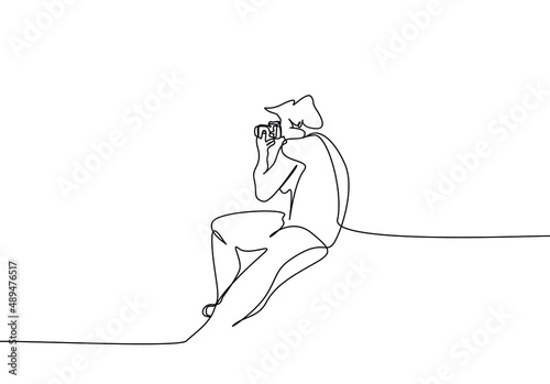 a male photographer captures a special pose and focuses with his camera