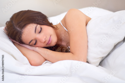 Peaceful dreaming. An attractive young woman sleeping in her bed.