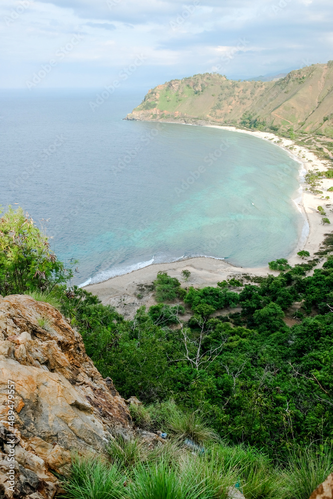 Beautiful view of Cristo Rei Backside Beach or known as Dolok Oan Beach in Dili, Timor Leste. Aerial view of tropical beach.