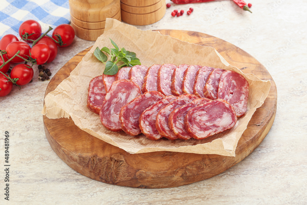 Sliced salami sausages over board Sliced salami sausages over board