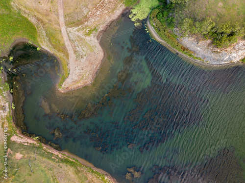 Eungella Dam Queensland Australia with low water levels showing texture in the and pattern in the shallows.