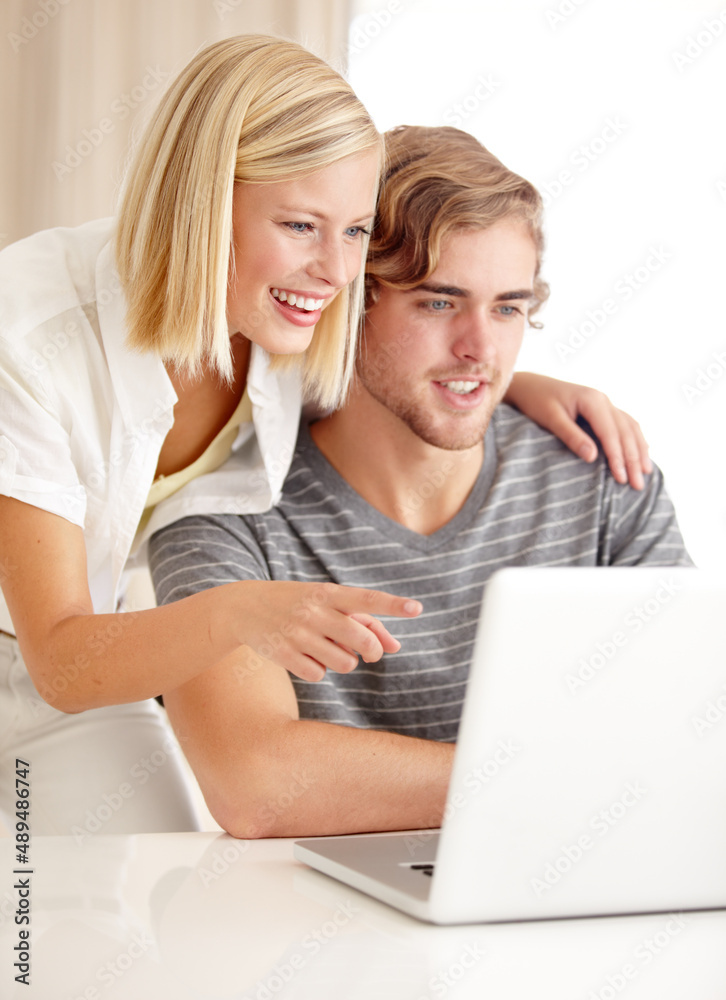 Open that link. A happy young couple using a laptop to surf the internet.