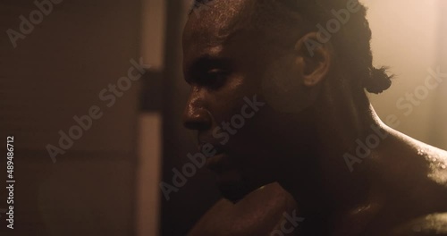 An Athlete Rests After An Intense Workout Session In A Crossfit Gym. Shot In An MMA Boxing Gym With Low Key Lighting And A Scattering Of Haze. Captured On Red Digital Cinema Camera 