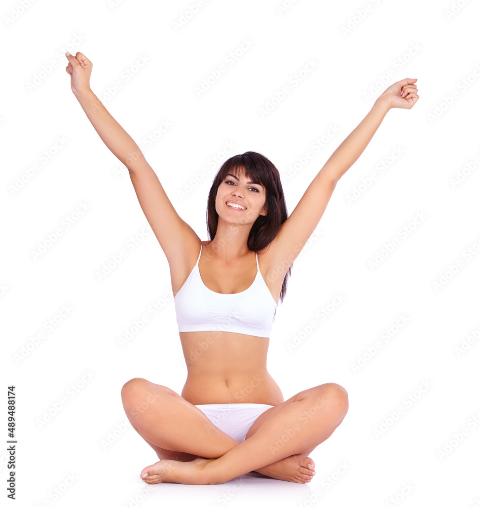 Stretching her fitness muscles. Studio portrait of a beautiful young woman in underwear stretching her arms out. Stretching her fitness muscles. Studio portrait of a beautiful young woman in underwear stretching her arms out.