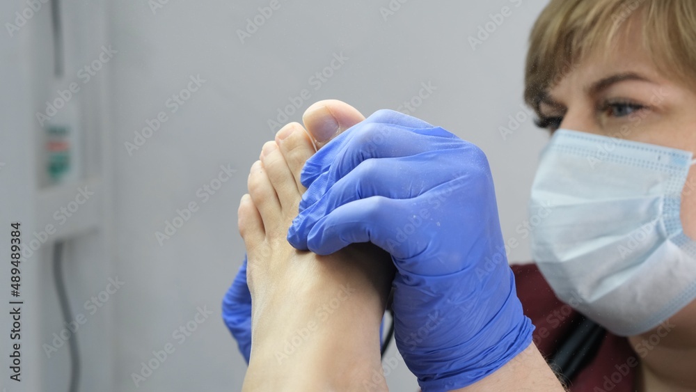 Patient on medical pedicure procedure, visiting podiatrist.Professional