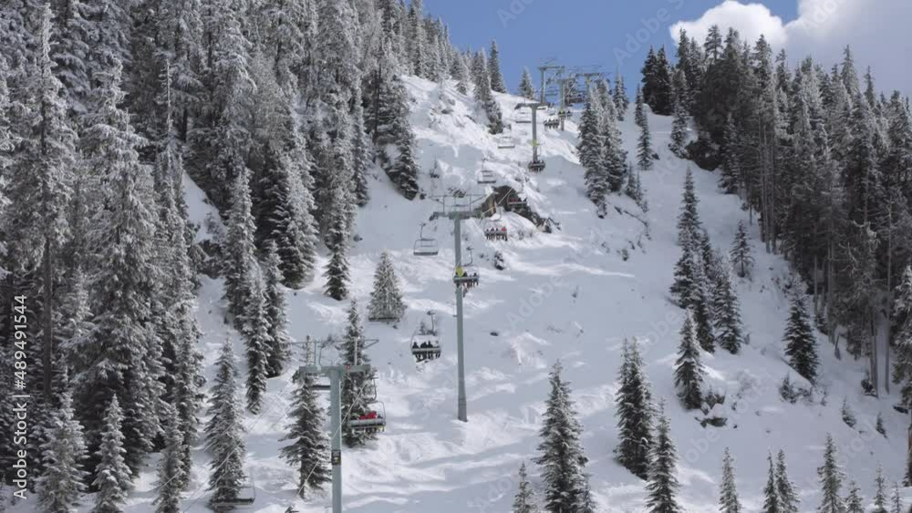 Whistler Mountain chairlift, ski mountain, sunny day, winter, ski hill. 4k 24fps Whistler Mountain chairlift, ski mountain, sunny day, winter, ski hill. 4k 24fps