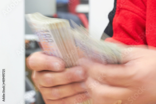 Calculating the profit. Cropped shot of a businessman counting money.