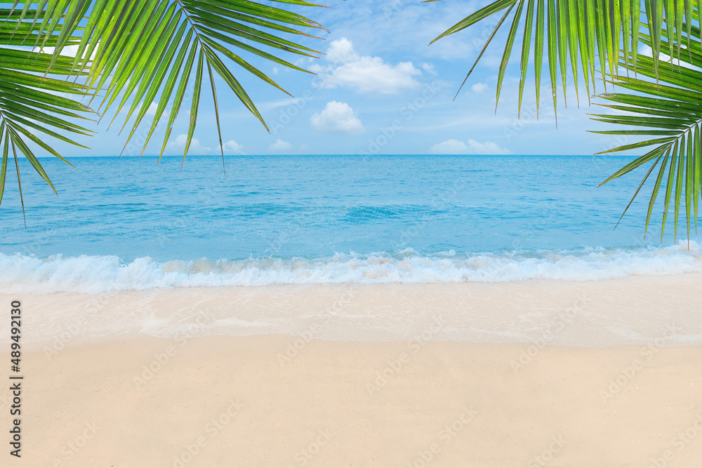 Fototapeta premium Sand with Palm and tropical beach and sea background. Summer vacation and travel concept.