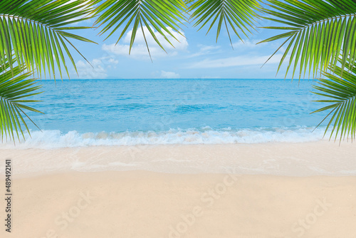 Sand with Palm and tropical beach and sea background. Summer vacation and travel concept. © LOVEis