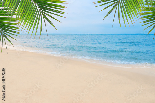 Sand with Palm and tropical beach and sea background. Summer vacation and travel concept. © LOVEis