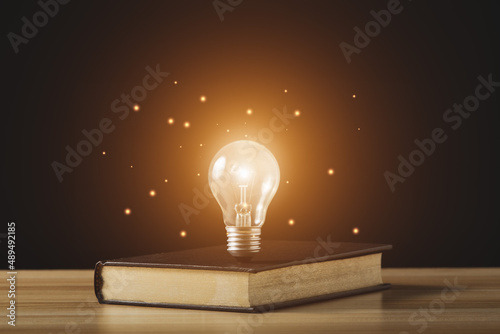 Light bulb and book. idea of ​​inspiration from reading, innovation idea concept.Book Day.