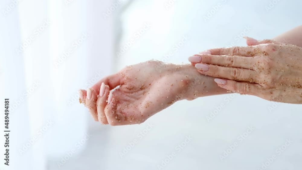 Close-up woman is hands with coffee massage scrub on monstera blurred background. Cosmetology, hand care, spa cosmetics, beauty concept. Close-up woman is hands with coffee massage scrub on monstera blurred background. Cosmetology, hand care, spa cosmetics, beauty concept.