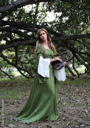 Fotografie Full length portrait of blondewoman wearing a  beautiful  green medieval fantasy gown